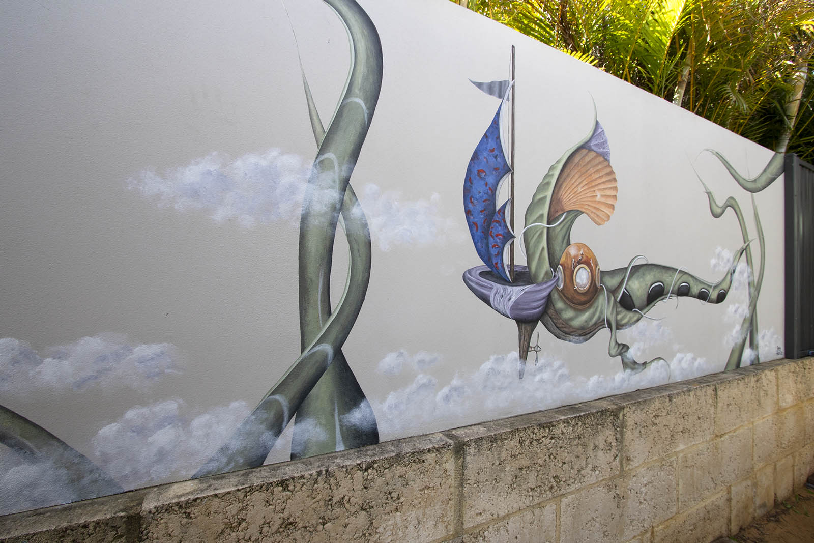 Outdoor mural of fantasy scene with diver's helment on green creature boat with sail